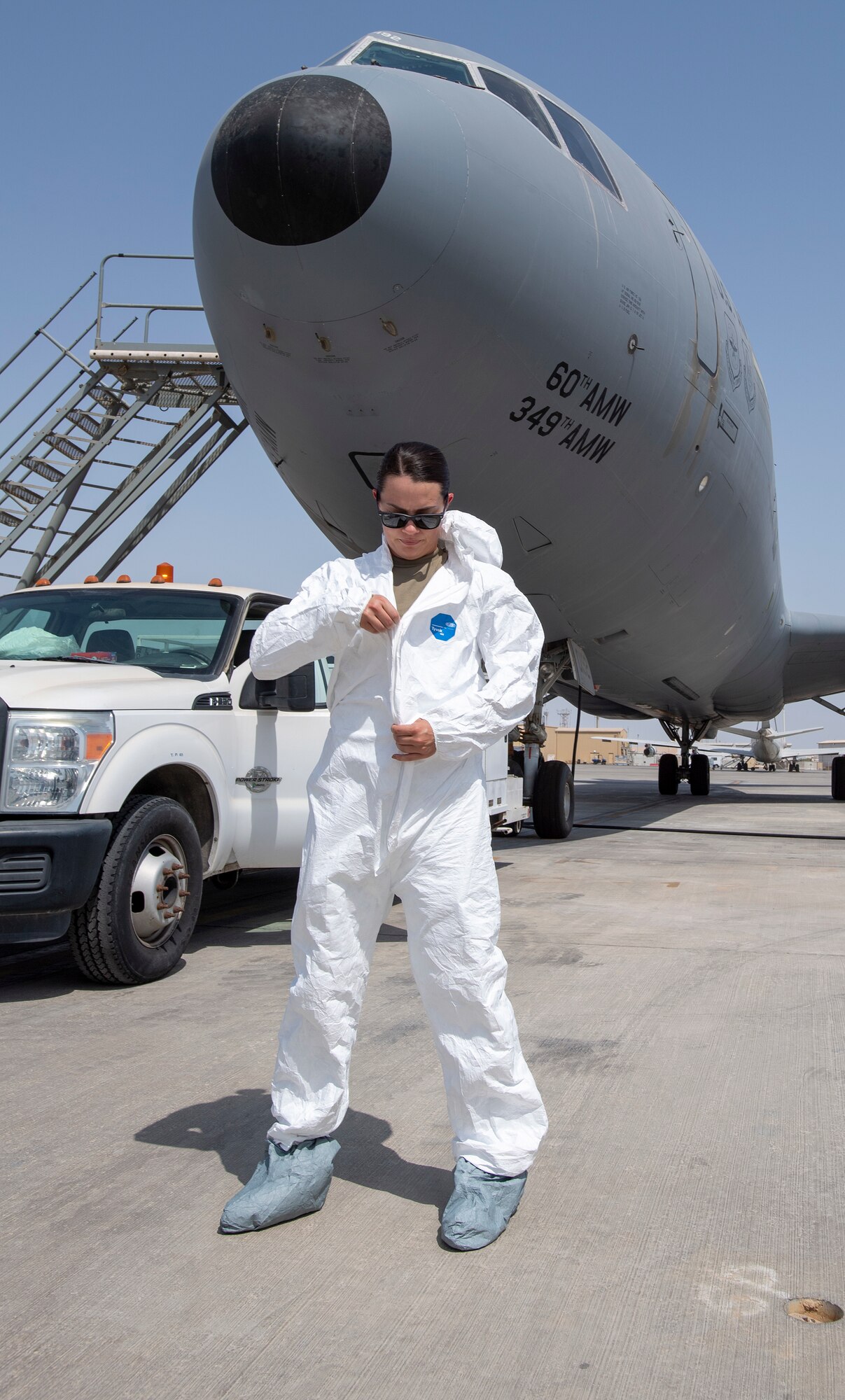 Female service members dons protective outer garment