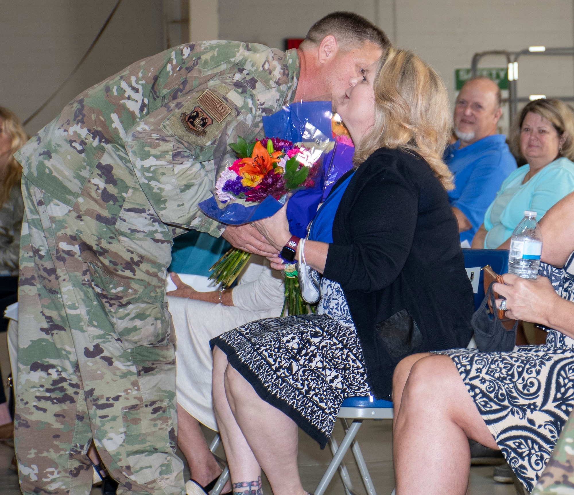 U.S. Air Force Lt. Col. McLeod hands his wife flowers and thanks her for her support on Aug. 7, 2021 at Whiteman Air Force Base, Mo. (U.S. Air Force photo by Maj. Shelley Ecklebe)