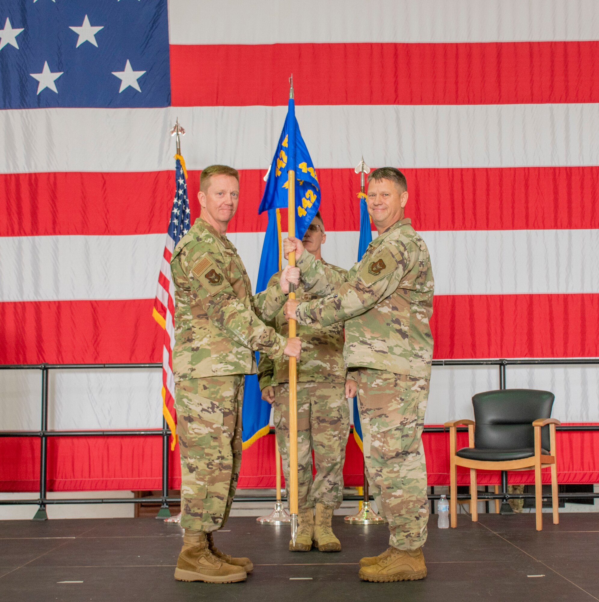 U.S. Air Force Brig. Gen. Michael Schultz, 442d Fighter Wing Commander, left, passes the unit flag to Lt. Col. William McLeod, in-coming 442d Maintenance Group Commander, for the 442d Maintenance Group assumption of command ceremony on Aug. 7, 2021 at Whiteman Air Force Base, Mo. (U.S. Air Force photo by Maj. Shelley Ecklebe)