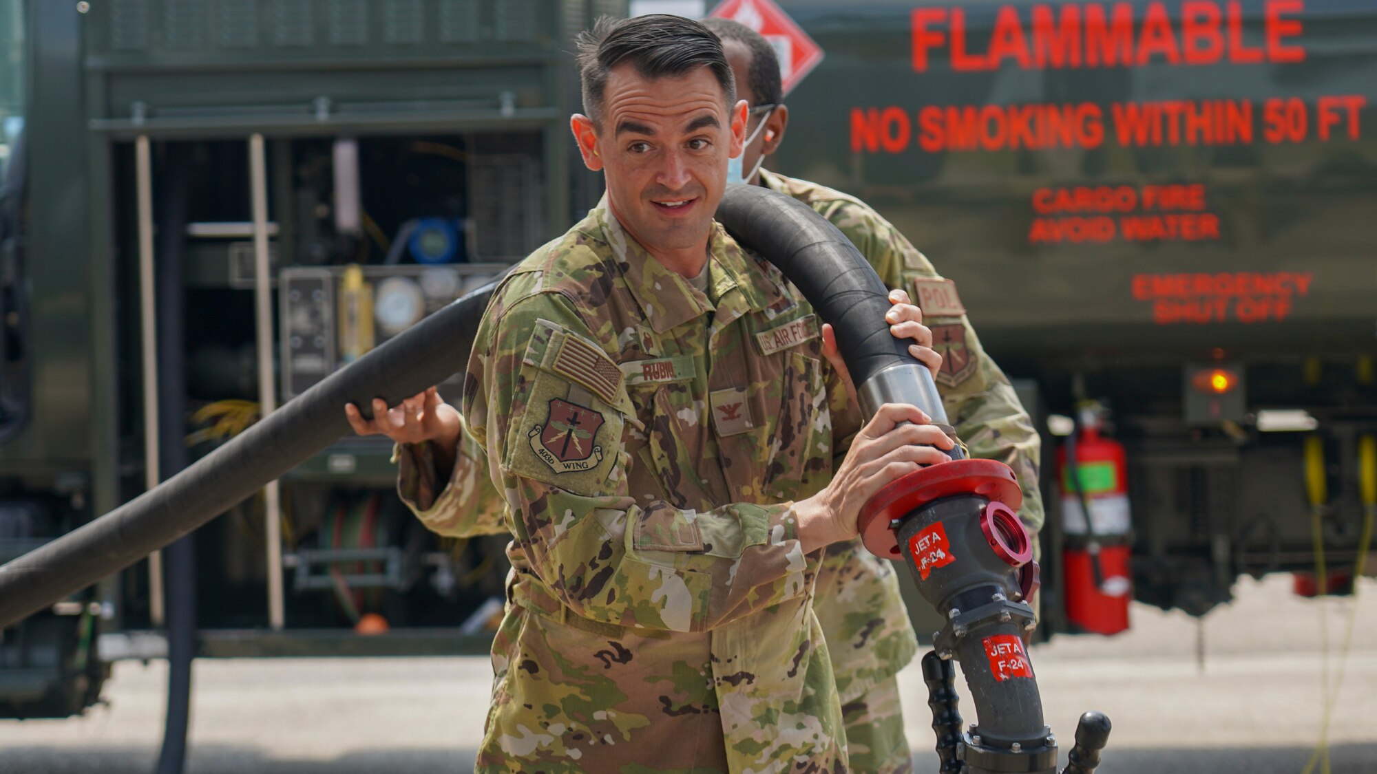 Col. Stuart M. Rubio, 403rd Wing commander, assists Tech. Sgt. Melvin Tucker, 403rd Logistics Readiness Squadron fuels operator, in carrying a hose from a fuel truck to a C-130J Super Hercules aircraft at Keesler Air Force Base, Miss., Aug. 7, 2021. Rubio met with the Reserve Citizen Airmen of the petroleum, oils and lubricants shop, aka POL, as part of his immersion tour with the 403rd LRS. (U.S. Air Force photo by 2nd Lt. Christopher Carranza)
