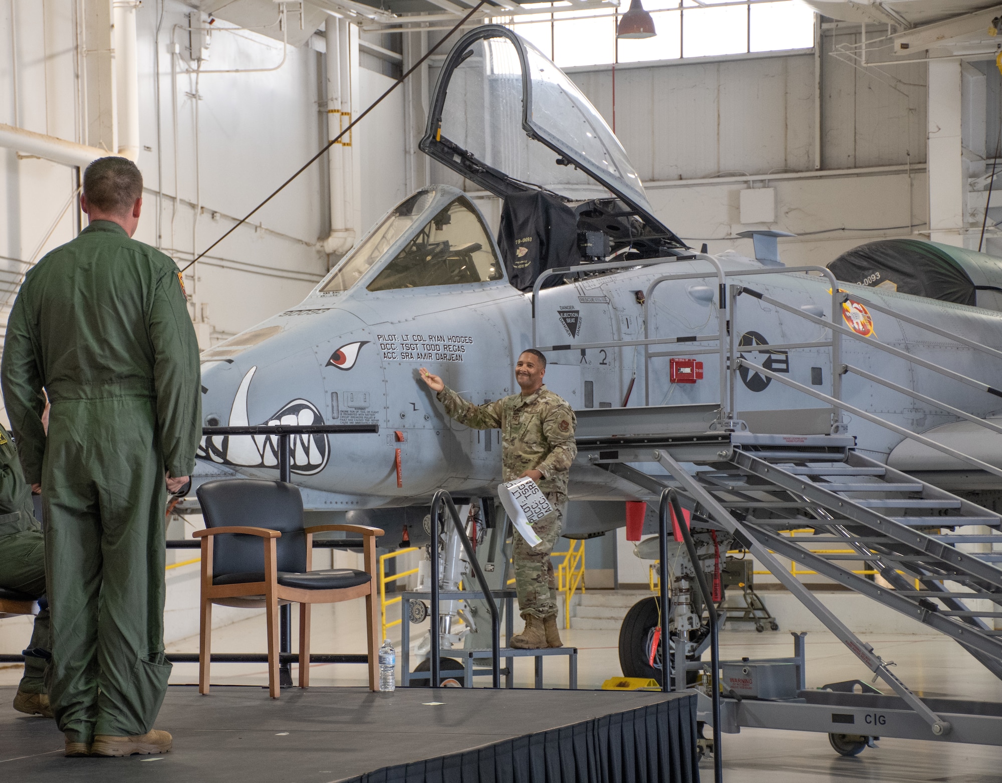 Tech. Sgt. Todd Regas, the dedicated crew chief of aircraft 79-093, unveils Lt. Col. Ryan Hodges’ name on his A-10C Thunderbolt II aircraft during the change of command ceremony on Aug. 7, 2021, at Whiteman Air Force Base, Mo. (U.S. Air Force photo by Maj. Shelley Ecklebe)