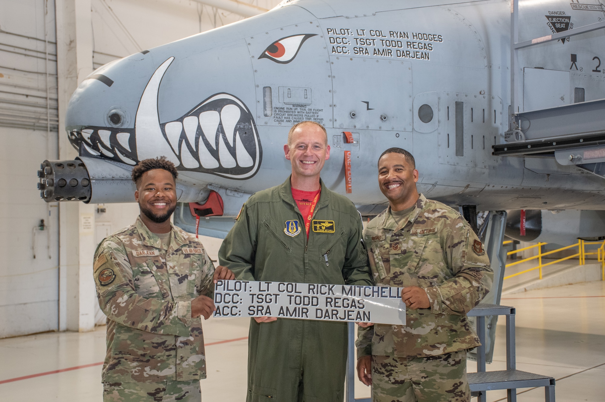 Tech. Sgt. Todd Regas, the dedicated crew chief of aircraft 79-093, and Senior Airman Ami Darjean, his assistant crew chief, pose with Lt. Col. Rick Mitchell, outgoing 303rd Fighter Squadron commander after the change of command ceremony on Aug. 7, 2021, at Whiteman Air Force Base, Mo. (U.S. Air Force photo by Maj. Shelley Ecklebe)