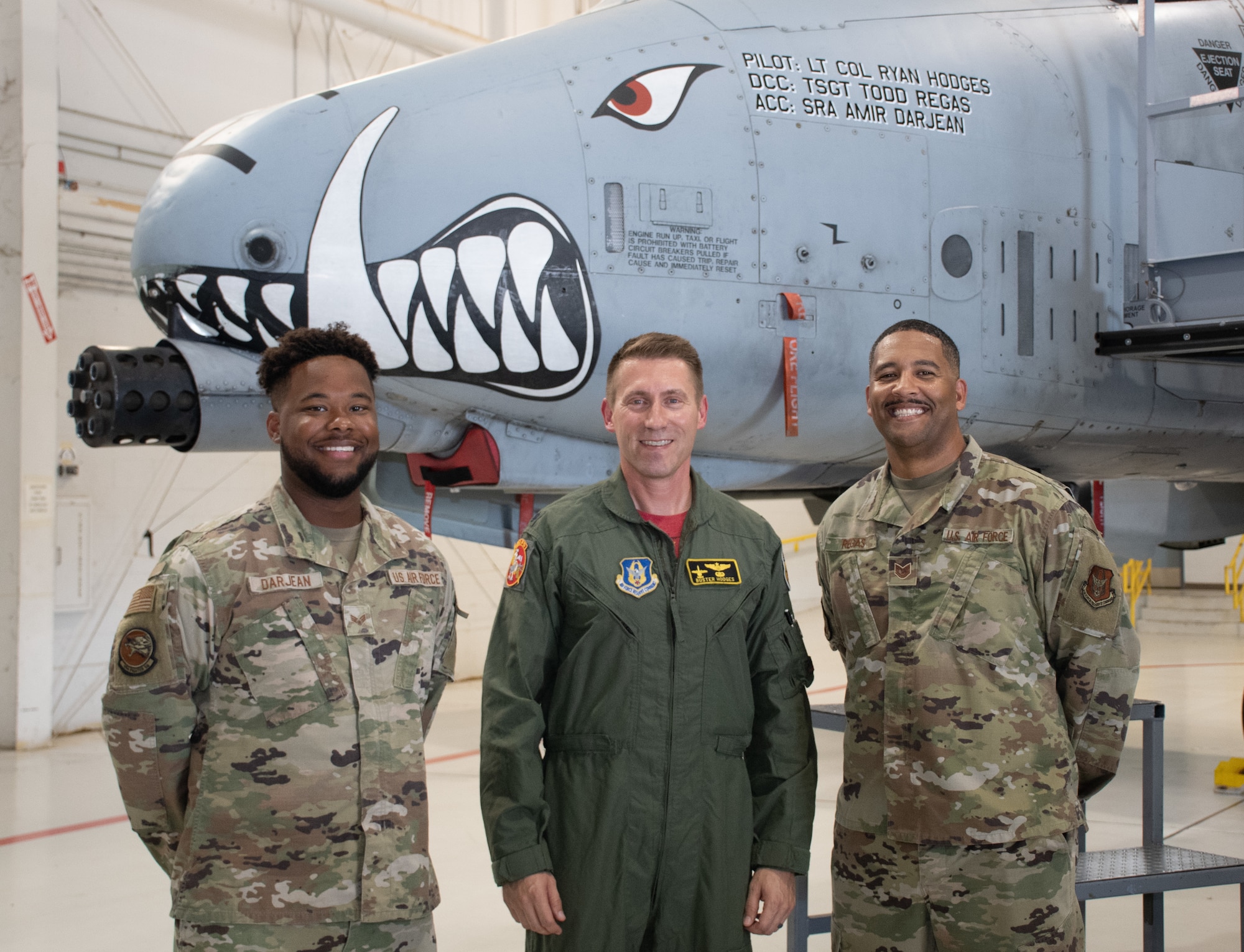 Tech. Sgt. Todd Regas, the dedicated crew chief of aircraft 79-093, and Senior Airman Ami Darjean, his assistant crew chief, pose with Lt. Col. Ryan Hodges, incoming 303rd Fighter Squadron commander after the change of command ceremony on Aug. 7, 2021, at Whiteman Air Force Base, Mo. (U.S. Air Force photo by Maj. Shelley Ecklebe)