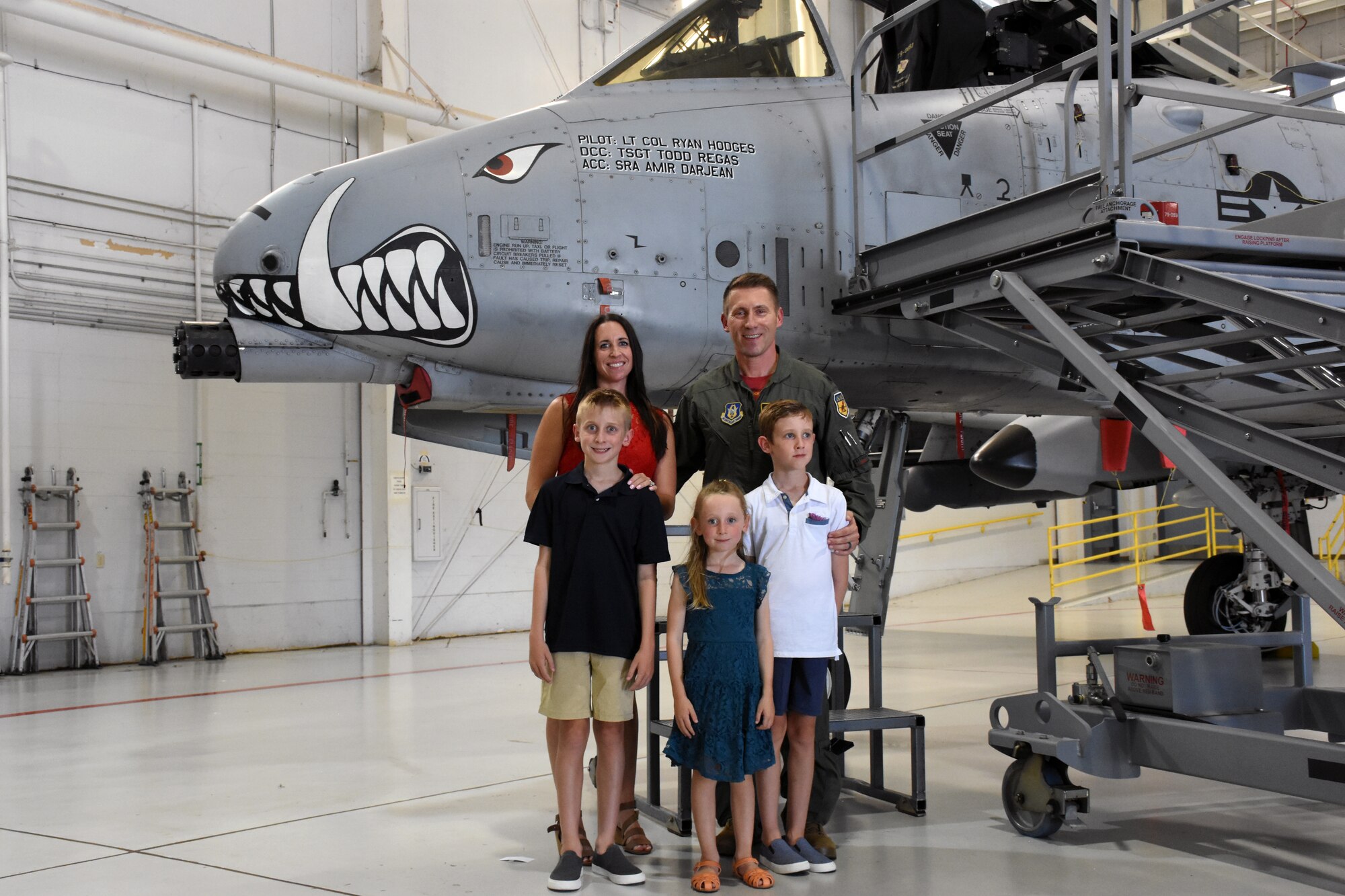 U.S. Air Force Lt. Col. Ryan Hodges stands with his family in front of his A-10C Thunderbolt II after taking command of the 303rd Fighter Squadron on Aug. 7, 2021, at Whiteman Air Force Base, Mo. (U.S. Air Force photo by Senior Airman Alex Chase)