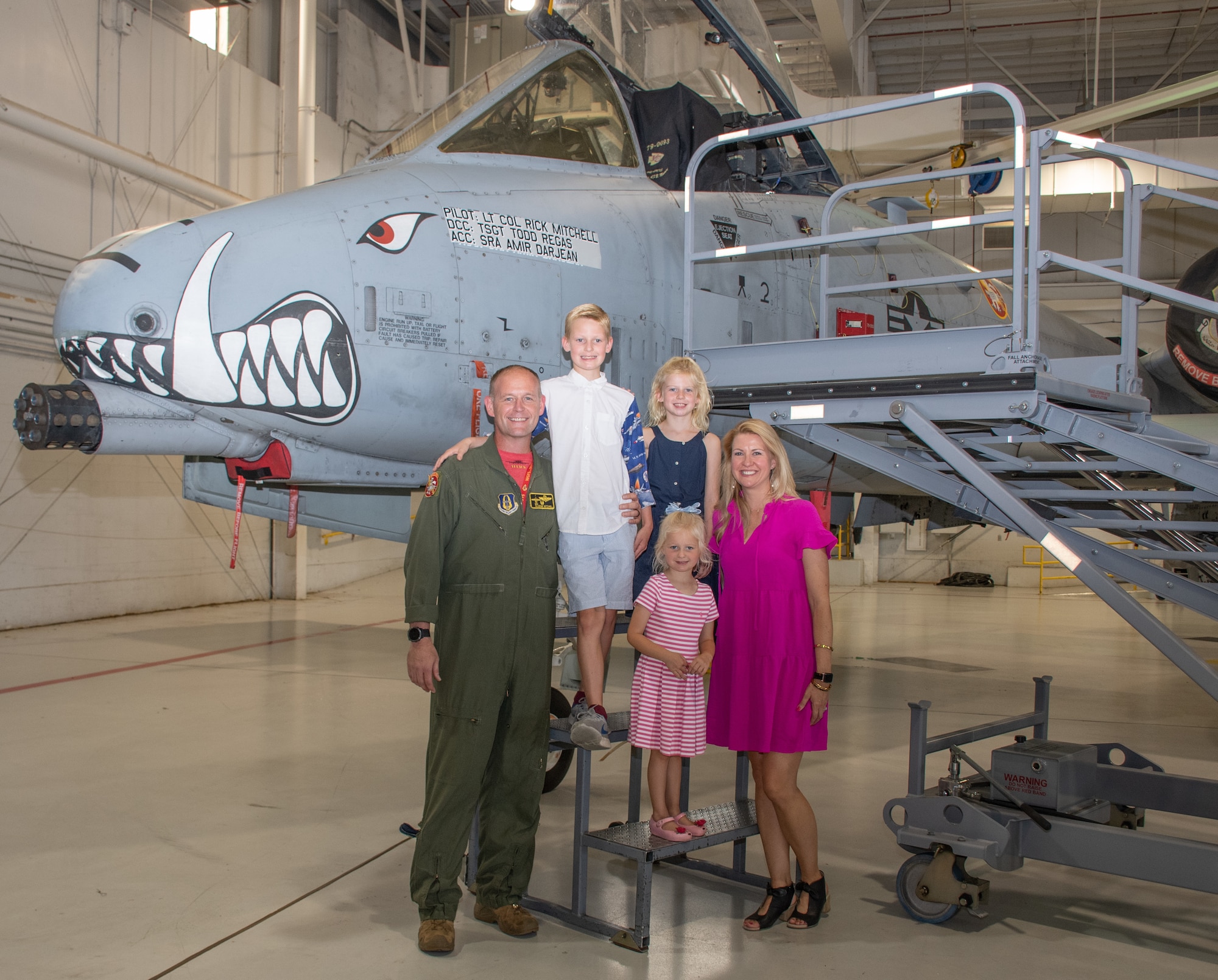 U.S. Air Force Lt. Col. Rick Mitchell and his family get one last picture in front of his A-10C Thunderbolt II prior to the 303rd Fighter Squadron change of command ceremony on Aug. 7, 2021, at Whiteman Air Force Base, Mo. (U.S. Air Force photo by Maj. Shelley Ecklebe)