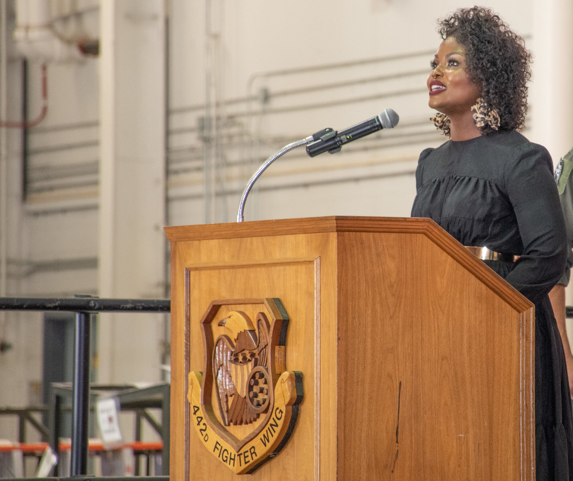 DoD Civilian, Mrs. Octaver Robinson sings the National Anthem during the 303rd Fighter Squadron change of command ceremony on Aug. 7, 2021, at Whiteman Air Force Base, Mo. (U.S. Air Force photo by Maj. Shelley Ecklebe)
