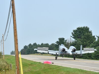 An A-10 Thunderbolt II pilot, 127th Wing, Selfridge Air National Guard Base, taxis down a public highway after landing Aug. 5, 2021. The training event marked the first time a modern military aircraft landed on a U.S. public highway designed only for automobiles.