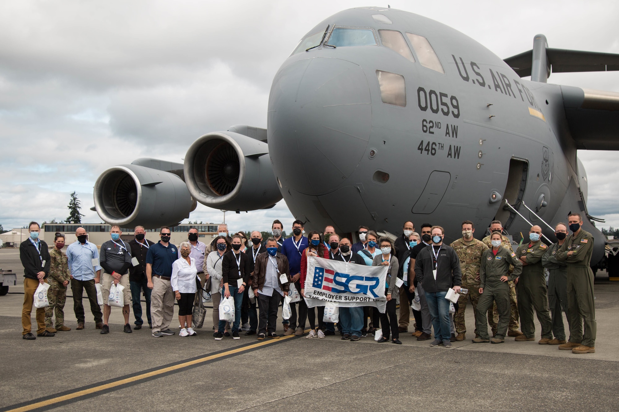 Civilian employers pose for a group photo in front of a C-1 7 Globemaster III