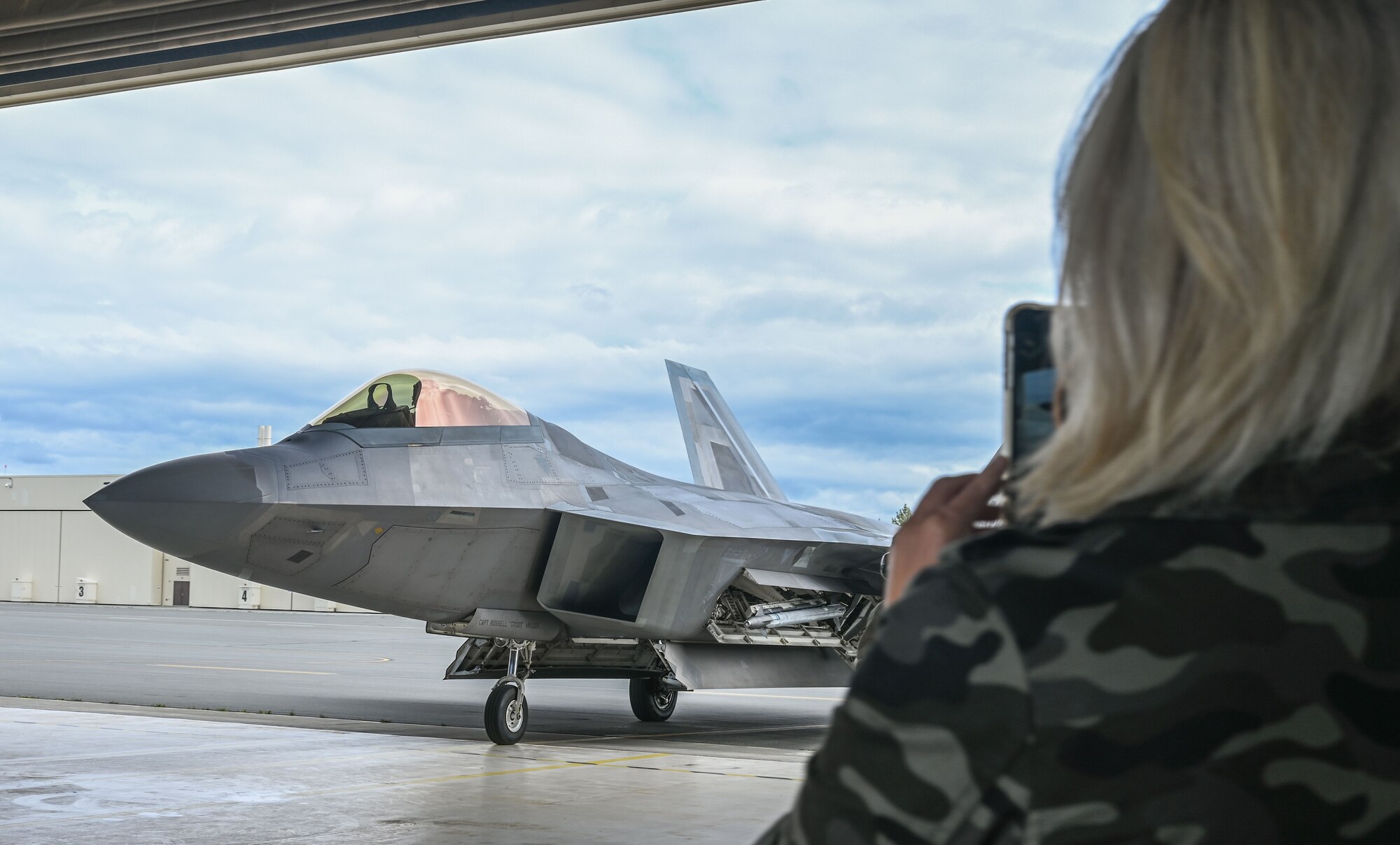 Lt. Col. Ryan Pelkola arrives from his flight while his wife takes a photo.