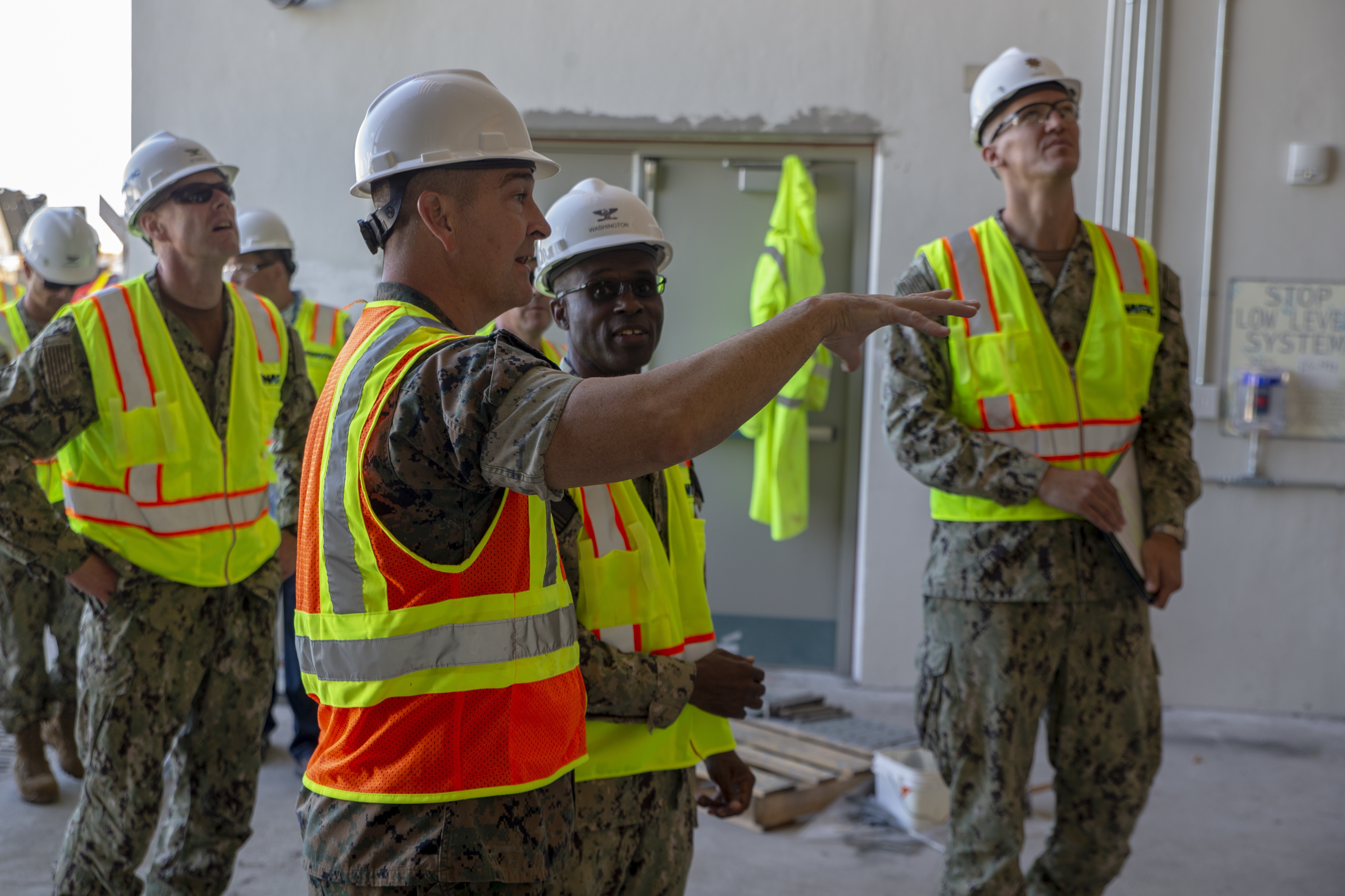 Lt. Col. Tate Buntz, the Marine Corps Base (MCB) Camp Blaz Operations Officer, right, briefs Will Boudra, the Naval Facilities Engineering Systems Command Pacific Guam Program Manager, during a visit to a MCB Camp Blaz construction site, July 29, 2021.