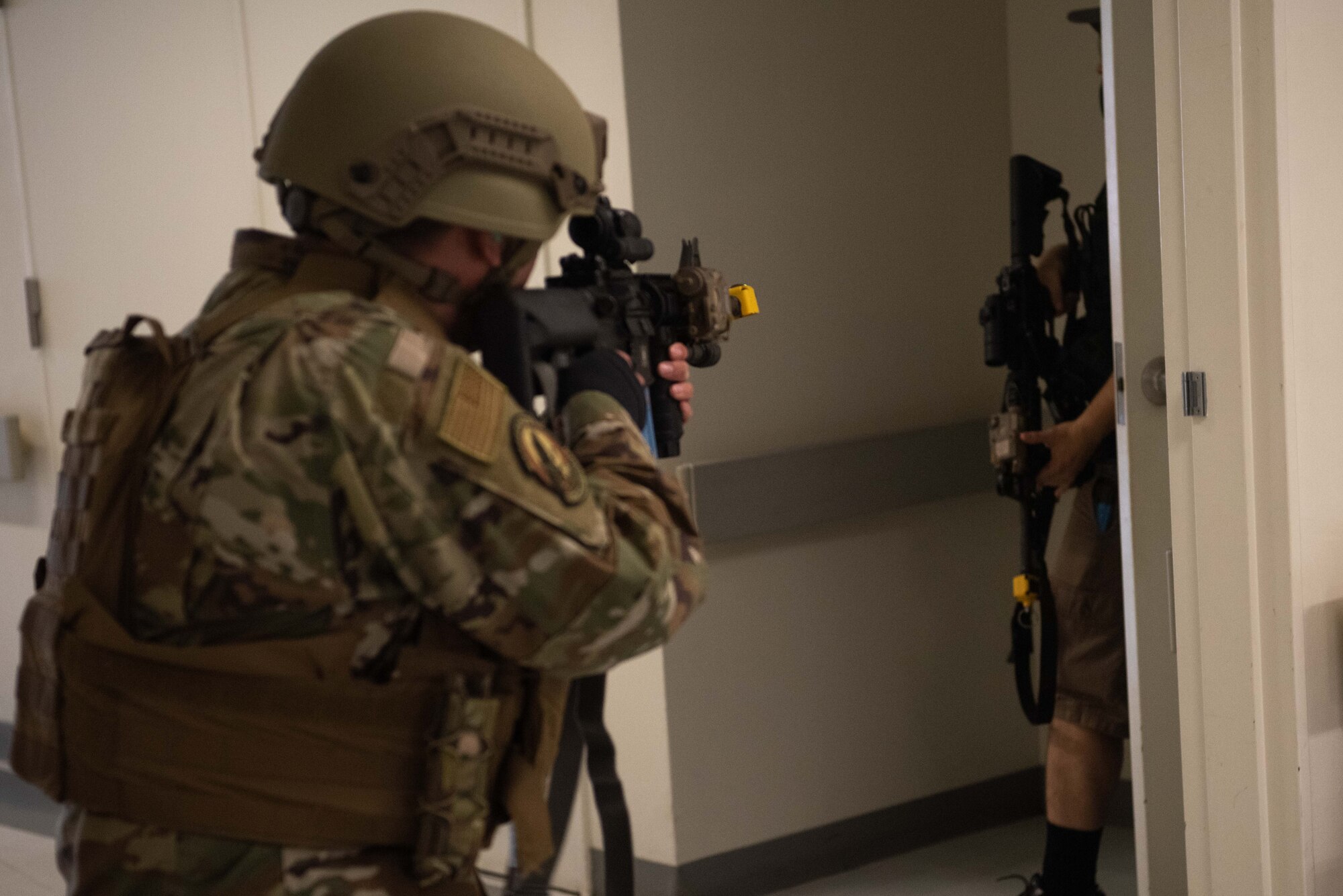 Security Forces member aims a weapon during active shooter response training.