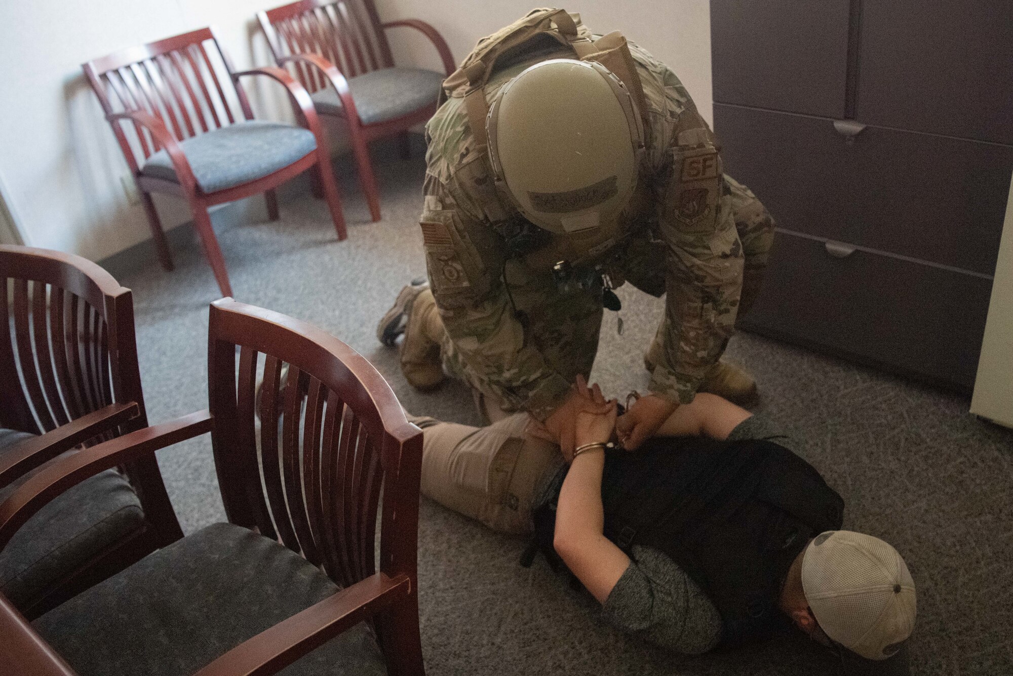 Security Forces member restrains an individual during active shooter response training.