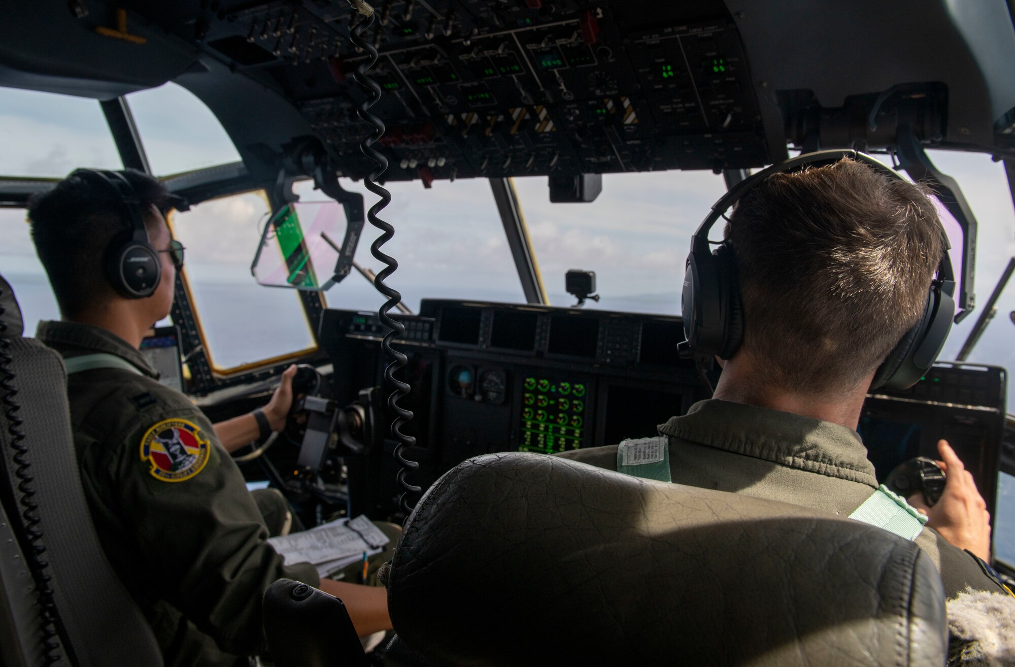 U.S. Air Force Capt. Yanzhi Zhuo and Capt. Zachary Holland, 36th Airlift Squadron pilots, fly over the Pacific Ocean July 27, 2021, during Pacific Iron 2021.