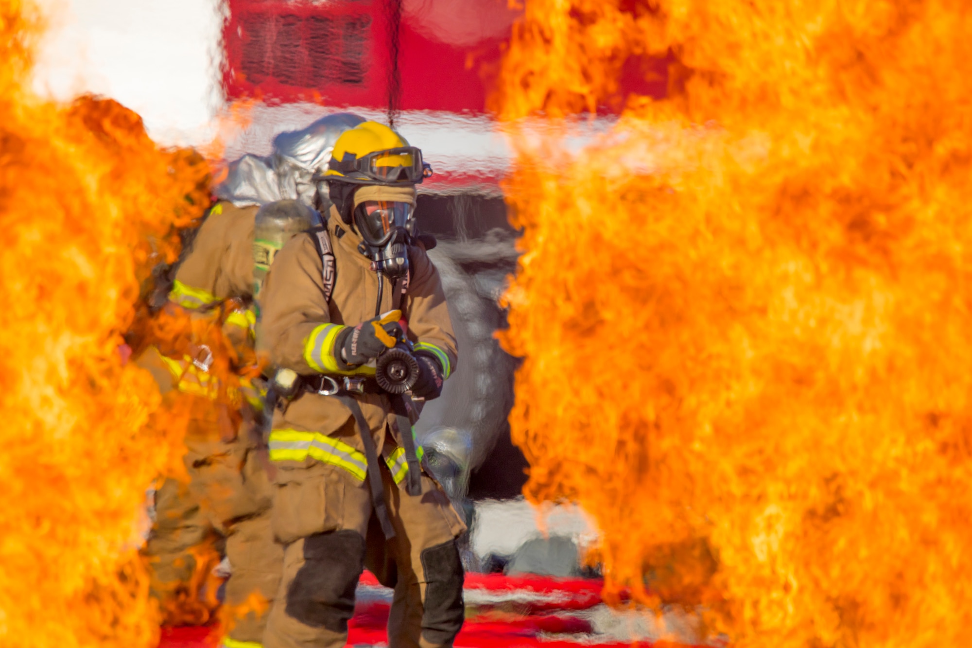 U.S. Marine Corps Lance Cpl. Cole McEachern, a fire fighter technician with Marine Wing Support Squadron 171 prepares to extinguish a fire during a controlled burn exercise at Andersen Air Force Base, Guam, July 28, 2021. Marines, Airmen, and Guam International Airport Fire Department crash fire rescue take part in annual training exercises in order to remain proficient in firefighting and rescue procedures to ensure safe airfield operations. (U.S. Marine Corps photo by Lance Cpl. Tyler Harmon)
