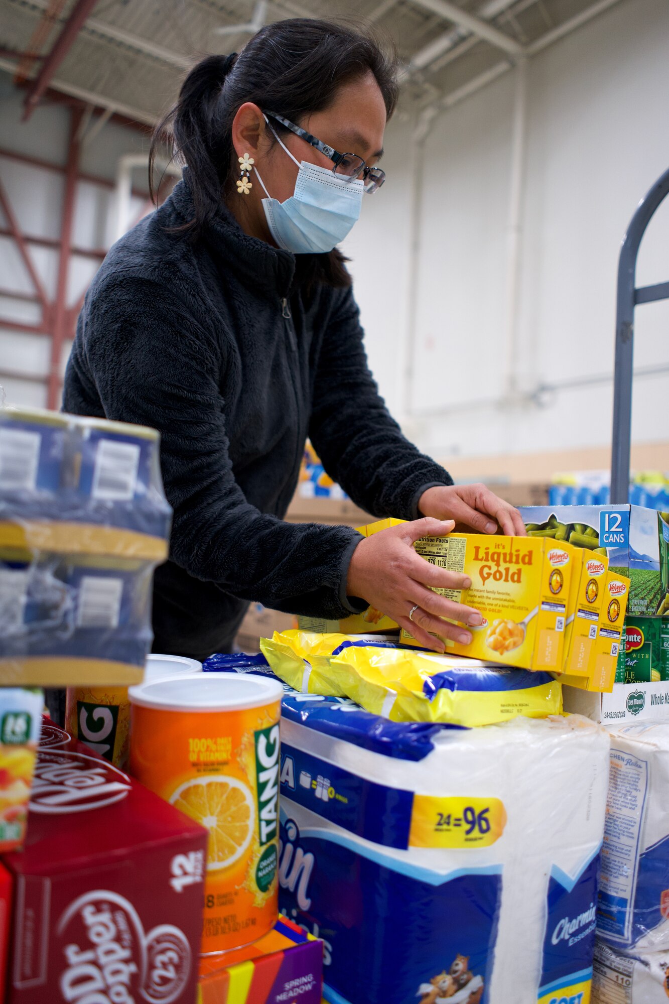 JOINT BASE ELMENDORF-RICHARDSON, Alaska -- Sharon Alexi, wife of retired Alaska Army National Guard Sgt. 1st Class Harry Alexi, arranges her shopping cart during a Commissary sale Aug. 7, 2021, at the Alaska Army National Guard Aviation Facility, Bethel, Alaska. An Alaska Air National Guard C-17 Globemaster III moved tons of groceries and supplies from Joint Base Elmendorf-Richardson to Bethel to offer the goods to eligible residents at discount prices. (U.S. Air National Guard photo by David Bedard/Released)