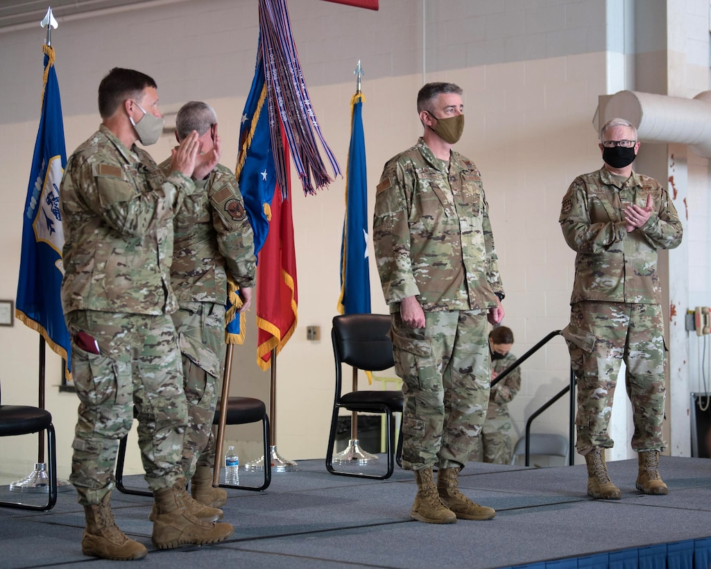 Brig. Gen. Jeffrey Wilkinson (left), Kentucky’s assistant adjutant general for Air, and Col. David Mounkes (right), outgoing commander of the Kentucky Air National Guard’s 123rd Airlift Wing, applaud Col. Bruce Bancroft, who officially took command of the wing during a ceremony at the Kentucky Air National Guard Base in Louisville, Ky., Aug. 7, 2021. Mounkes, who had served as wing commander since 2016, has been named director of policy for air operations, plans and programs at Joint Forces Headquarters—Kentucky. (U.S. Air National Guard photo by Phil Speck)