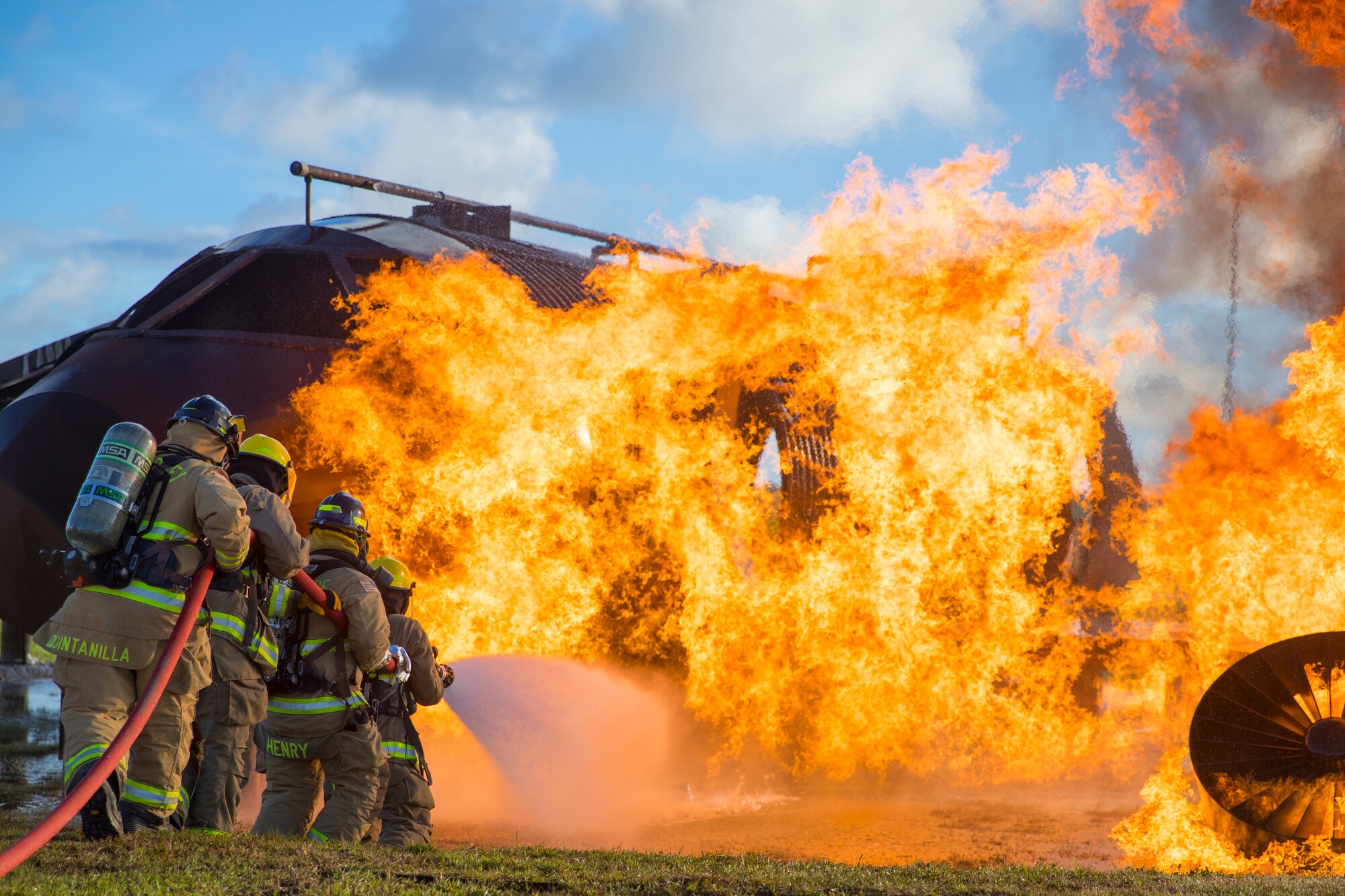 U.S. Marines with Marine Wing Support Squadron 171 and Airmen with the Andersen Air Force Base Fire and Emergency Services, 36th Civil Engineer Squadron extinguish a fire during a controlled burn exercise at Andersen Air Force Base, Guam, July 28, 2021. Marines, Airmen, and Guam International Airport Fire Department crash fire rescue take part in annual training exercises in order to remain proficient in firefighting and rescue procedures to ensure safe airfield operations. (U.S. Marine Corps photo by Lance Cpl. Tyler Harmon)