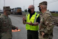 Mike Austin, director of hazardous materials for CSX transportation, speaks with Joint Task Force Civil Support Commanding General Maj. Gen. Jeff Van and Brig. Gen. William Prendergast, commander of Task Force 51, during a distinguished visitors day as part of exercise Vibrant Response 21.2.