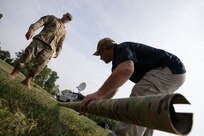 Dave Eure and Air Force Master Sgt. Joshua Buford, both assigned to Joint Task Force Civil Support’s communications directorate, set up a high-frequency antenna for a communication check as part of exercise Vibrant Response 21.2.