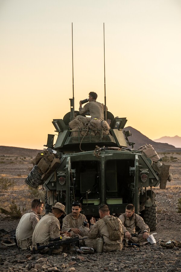 U.S. Marines with Delta Company, 4th Light Armored Reconnaissance Battalion, 4th Marine Division, eat chow prior to platoon attacks during Integrated Training Exercise (ITX) 4-21 at Marine Corps Air Ground Combat Center, Twentynine Palms, California on Aug. 2, 2021. ITX is the culmination of Marine Forces Reserve units’ training cycle as they participate in a live-fire, combined arms exercise as a part of an integrated Marine Air Ground Task Force. (U.S. Marine Corps photo by 2nd Lt. Gregory Dreibelbis)