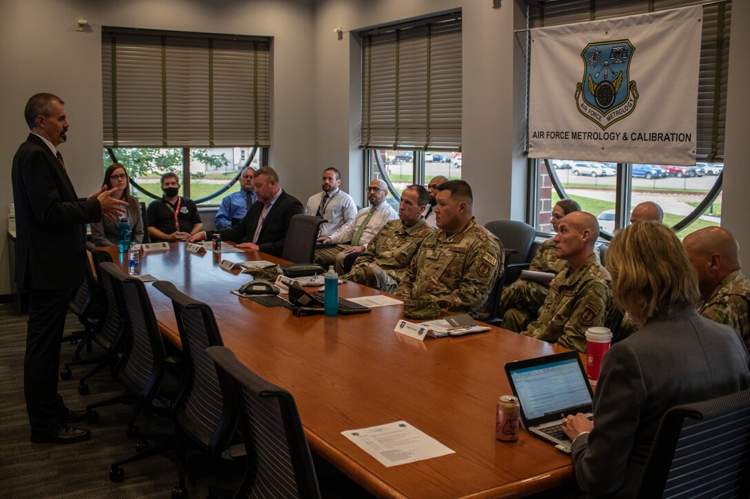 Carl Unholz, Air Force Metrology and Calibration Program director, briefs Lt. Gen. Shaun Q. Morris, Air Force Life Cycle management Center commander, and Chief Master Sgt. Jamie L. Newman, AFLCMC Command Chief, about the capabilities and functionality of the AFMETCAL program during a site visit at the Air Force Primary Standards Laboratory, Heath, Ohio, July 15, 2021. (U.S. Air Force photo by Tech. Sgt. Matthew B. Fredericks)