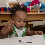 Amani Bailey, daughter of Tech. Sgt. Justin Bailey, 436th Aerial Port Squadron noncommissioned officer in charge of passenger services, paints as part of the Family Child Care program on Dover Air Force Base, Delaware, July 20, 2021. The FCC program offers an alternate option to the Child Development Center or Youth Center on base, providing in-home care for infants through school-aged children. (U.S. Air Force photo by Tech. Sgt. Nicole Leidholm)