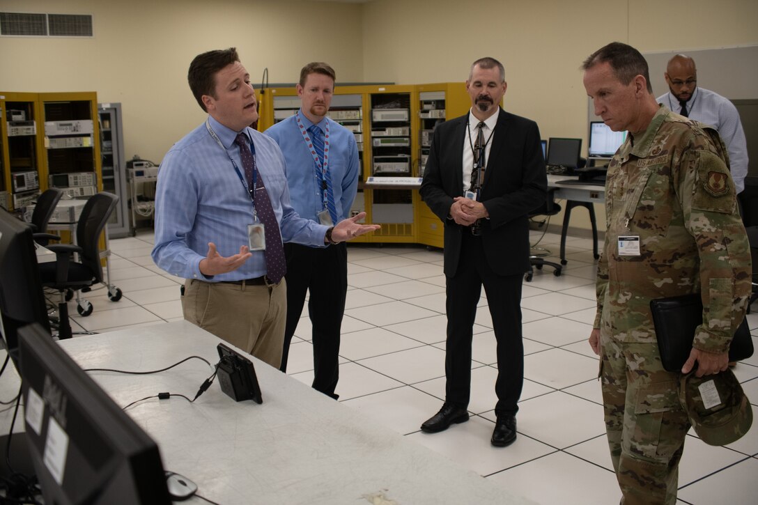 Kaleb Reed, Air Force Metrology and Calibration technician, briefs Lt. Gen. Shaun Q. Morris, Air Force Life Cycle Management Center commander, about the capabilities and functionality of precision measurement equipment at the Air Force Primary Standards Laboratory, Heath, Ohio, during a site visit July 15, 2021.  (U.S. Air Force photo by Tech. Sgt. Matthew B. Fredericks)