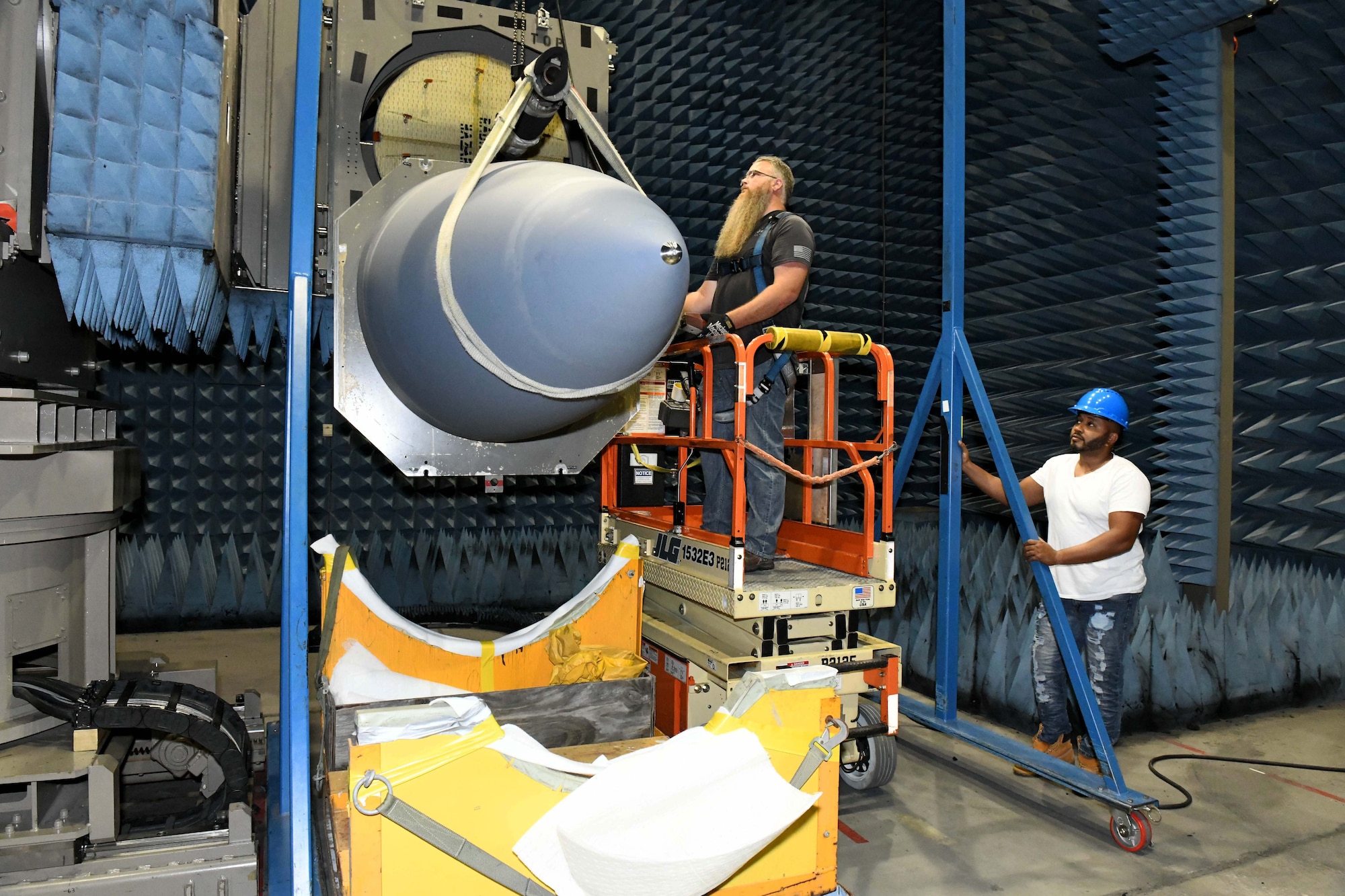 men hoisting aircraft nose cone