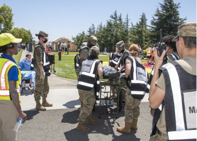 Airmen assigned to the 60th Medical Group participate in a simulated event during an exercise July 22, 2021, at Travis Air Force Base, California. The disaster response exercise prepared David Grant Medical Center staff to respond to chemical, biological, radiological, nuclear, or explosive incidents. (U.S. Air Force photo by Heide Couch)