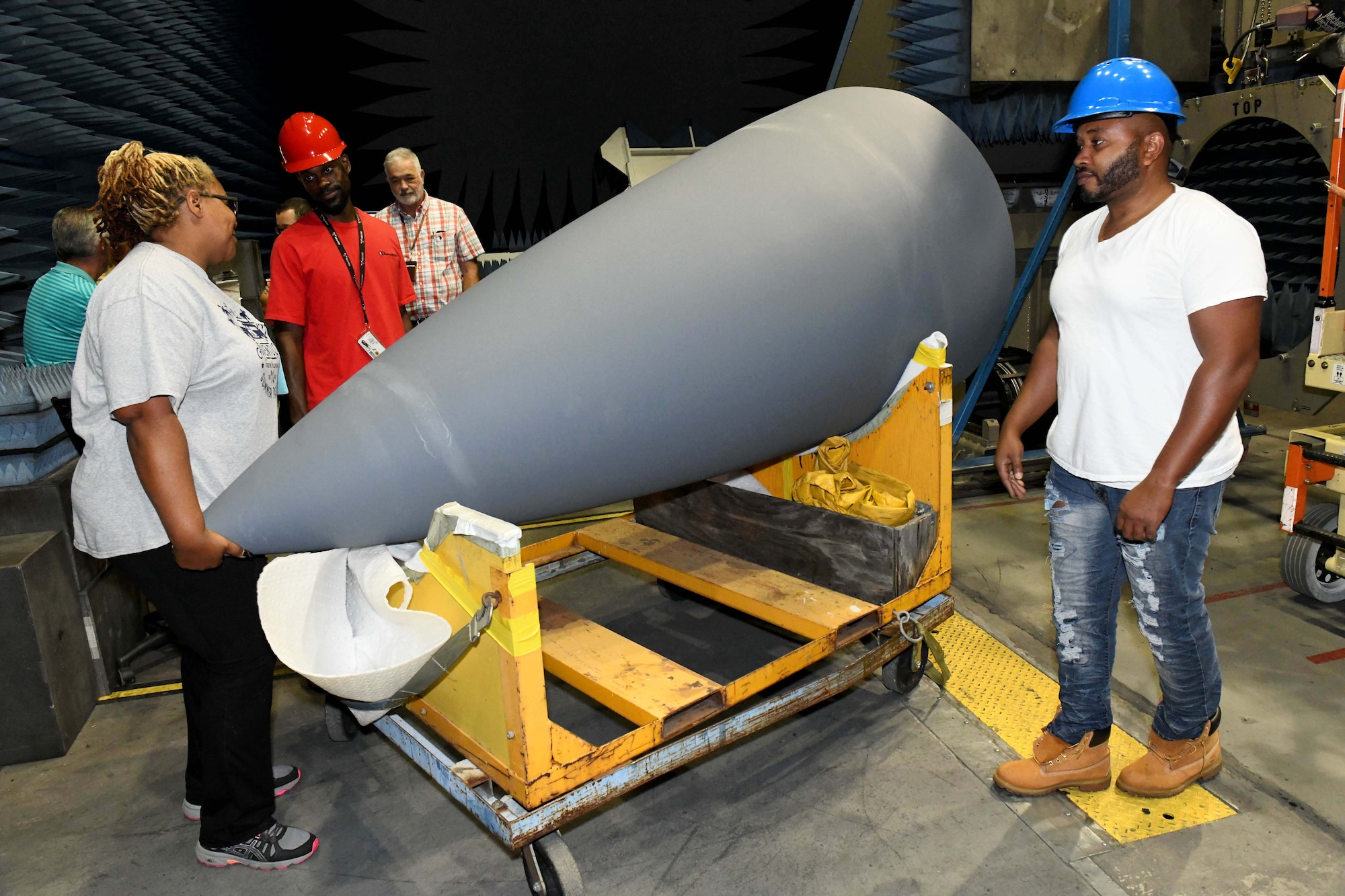 Electronic Technicians moving aircraft nose cone