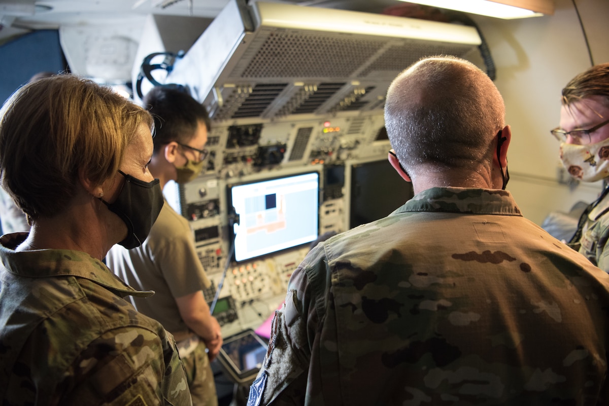 Airmen looking at aircraft console