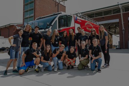 Freedom Academy participants pose for a photo in front of a fire engine