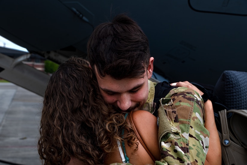 Senior Airman Jimmie Norton, 15th Airlift Squadron loadmaster, hugs his wife after returning from his deployment at Joint Base Charleston, S.C., Aug. 8, 2021.