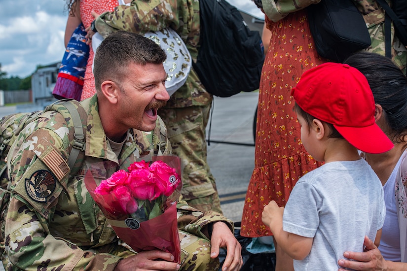 Maj. Andrew Mills, 16th Airlift Squadron pilot, is welcomed home from his deployment by his son at Joint Base Charleston, S.C., Aug. 8, 2021.