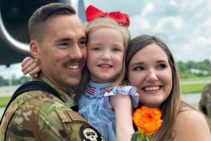 Capt. Dan Tenpas, 16th Airlift Squadron pilot, poses with his wife and daughter after returning from his deployment at Joint Base Charleston, S.C., Aug. 8, 2021.