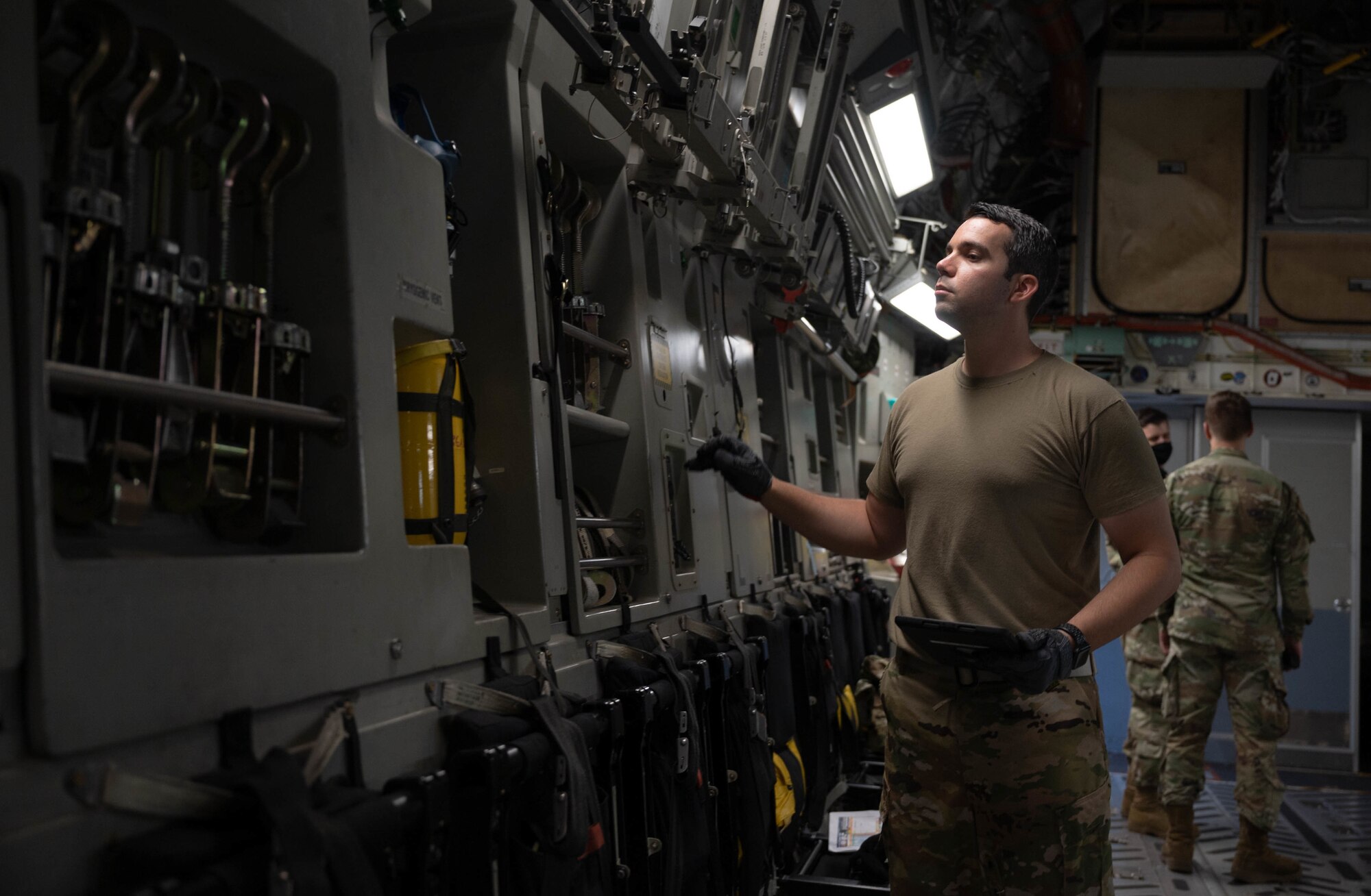 Staff Sgt. Scott Ackerly, 3rd Airlift Squadron loadmaster, performs pre-flight checks on a C-17 Globemaster III before a local training flight at Dover Air Force Base, Delaware, Aug. 4, 2021. The 3rd AS routinely trains to ensure aircrew operational readiness to support global operations through delivery of time-critical assets. (U.S. Air Force photo by Senior Airman Faith Schaefer)