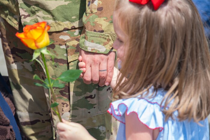Capt. Dan Tenpas, 16th Airlift Squadron pilot, holds his daughter’s hand after returning from his deployment at Joint Base Charleston, S.C., Aug. 8, 2021.