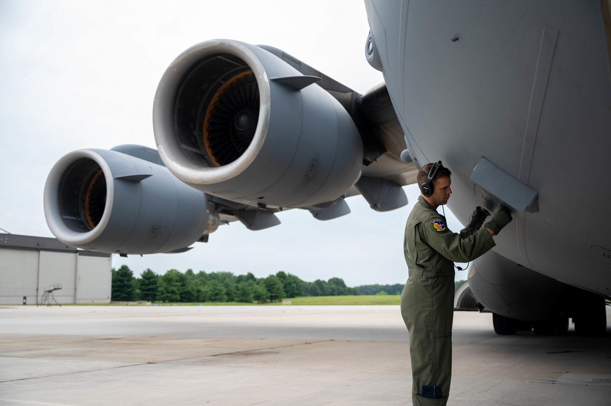 Maj. Daniel Velo, 3rd Airlift Squadron pilot, closes an external power outlet on a C-17 Globemaster III before a local training flight at Dover Air Force Base, Delaware, Aug. 4, 2021. The 3rd AS routinely trains to ensure aircrew operational readiness to support global operations through delivery of time-critical assets. (U.S. Air Force photo by Senior Airman Faith Schaefer)