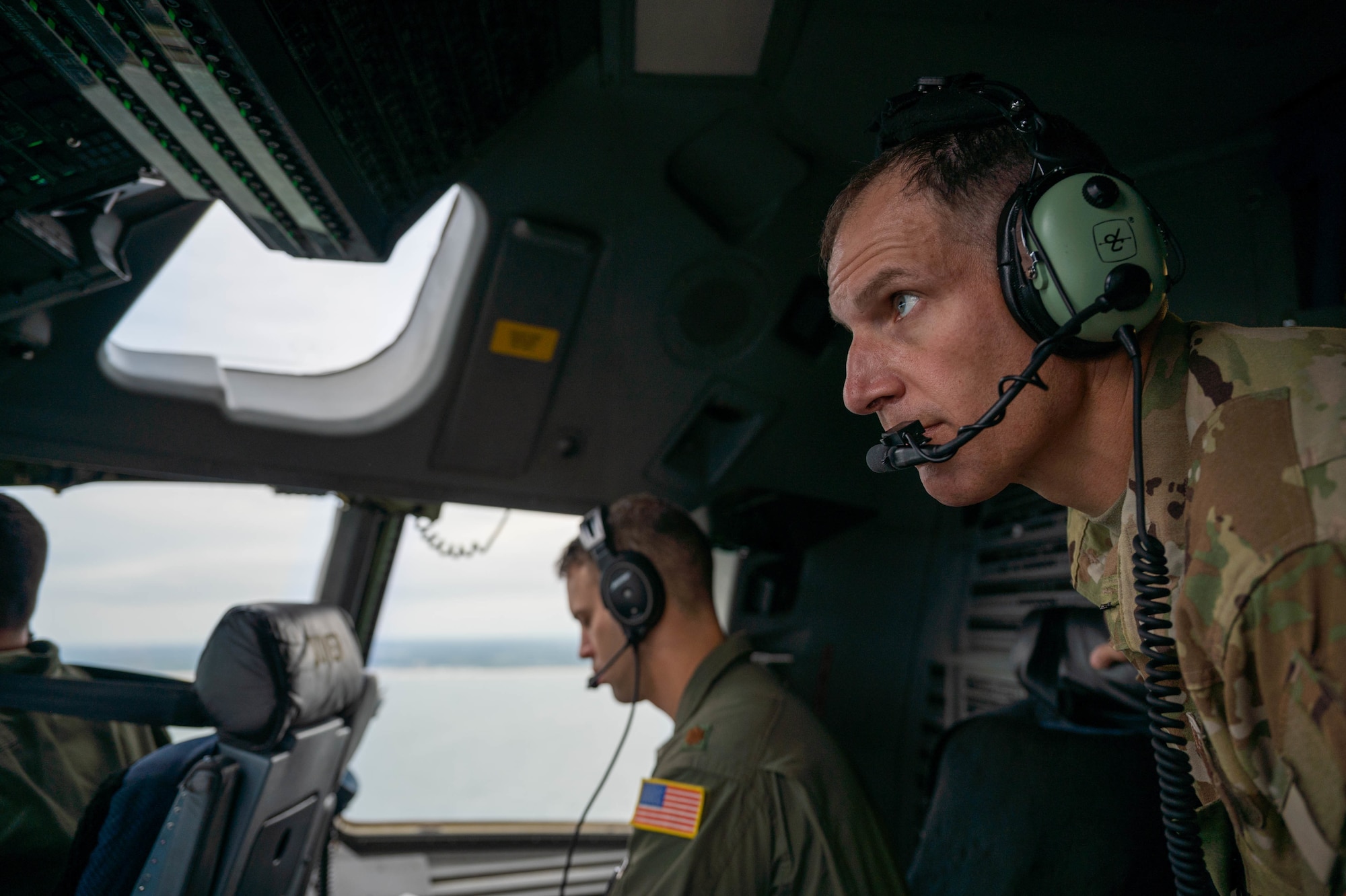 Col. Matt Husemann, 436th Airlift Wing commander, looks out a window from the flight deck of a C-17 Globemaster III during a local training flight over Delaware, Aug. 4, 2021. The 3rd AS routinely trains to ensure aircrew operational readiness to support global operations through delivery of time-critical assets. (U.S. Air Force photo by Senior Airman Faith Schaefer)