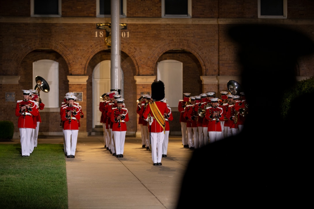 Marines with “The President’s Own, U.S. Marine Band perform during a Friday Evening Parade at Marine Barracks Washington, Aug. 6, 2021.