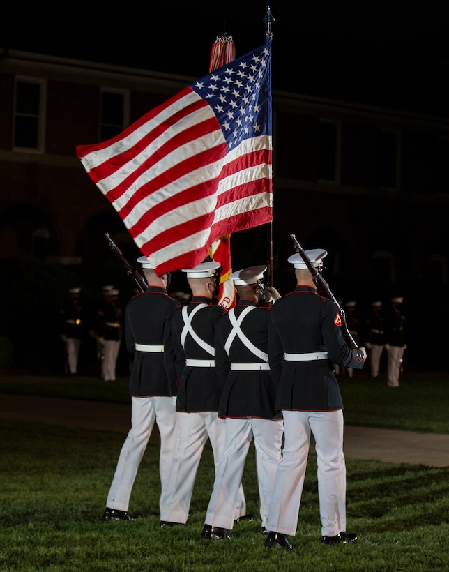 Marines with the Official Marine Corps Color Guard march across the parade deck during a Friday Evening Parade at Marine Barracks Washington, Aug. 6, 2021.