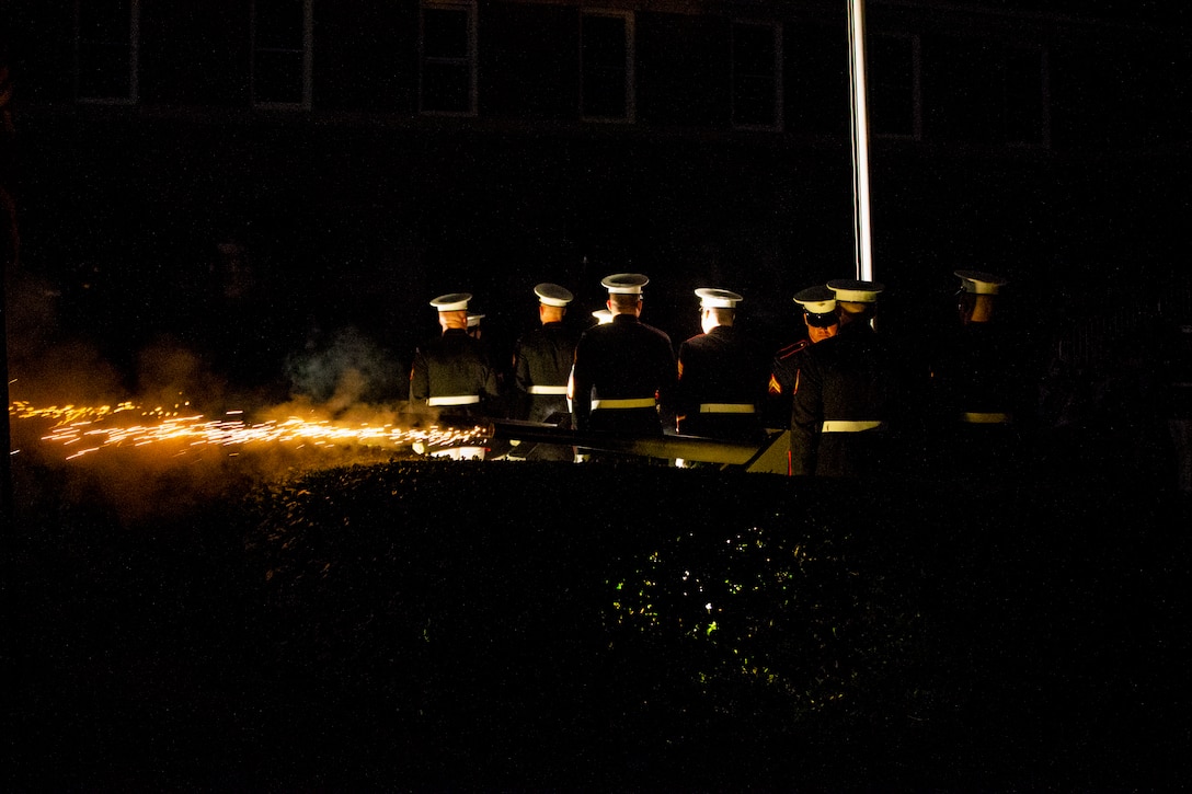 Body Bearers with Marine Barracks Washington conduct a cannon fire salute during a Friday Evening Parade at Marine Barracks Washington, Aug. 6, 2021.