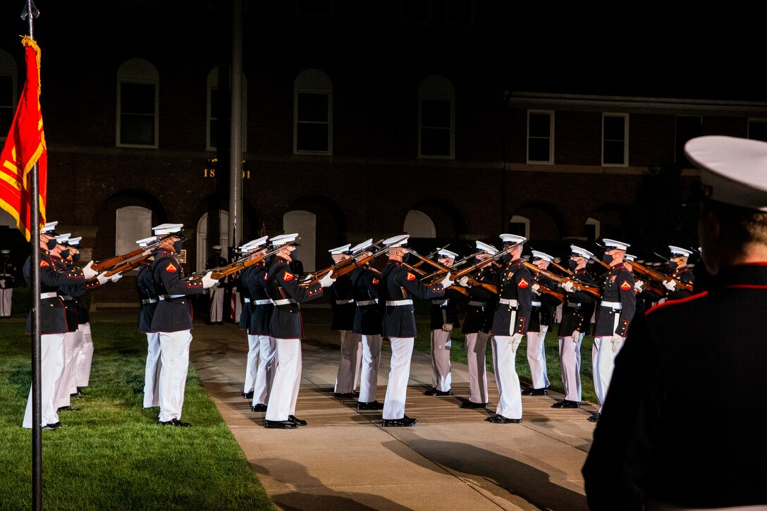 Marines with the Silent Drill Platoon perform during a Friday Evening Parade at Marine Barracks Washington, Aug. 6, 2021. The guests of honor for the evening were Chief Warrant Officer 4 Hershel W. “Woody” Williams, World War II Medal of Honor Recipient, Col. Harvey C. “Barney” Barnum, Vietnam War Medal of Honor Recipient, and Cpl. William K. “Kyle” Carpenter, Global War on Terrorism (Afghanistan) Medal of Honor Recipient, and the hosting officials were the 38th Commandant of the Marine Corps, Gen. David H. Berger, and the 19th Sergeant Major of the Marine Corps, Sgt. Maj. Troy E. Black. (U.S. Marine Corps photo by Lance Cpl. Allen Sanders)