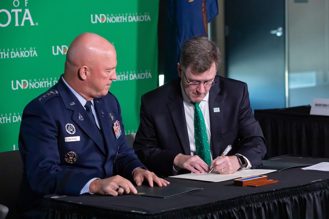 Chief of Space Operations Gen. John W. “Jay” Raymond and University of North Dakota President Andy Armacost and sign a Memorandum of Understanding Aug 9, 2021 in Robin Hall in Grand Forks, N.D. Photo by Shawna Noel Schill