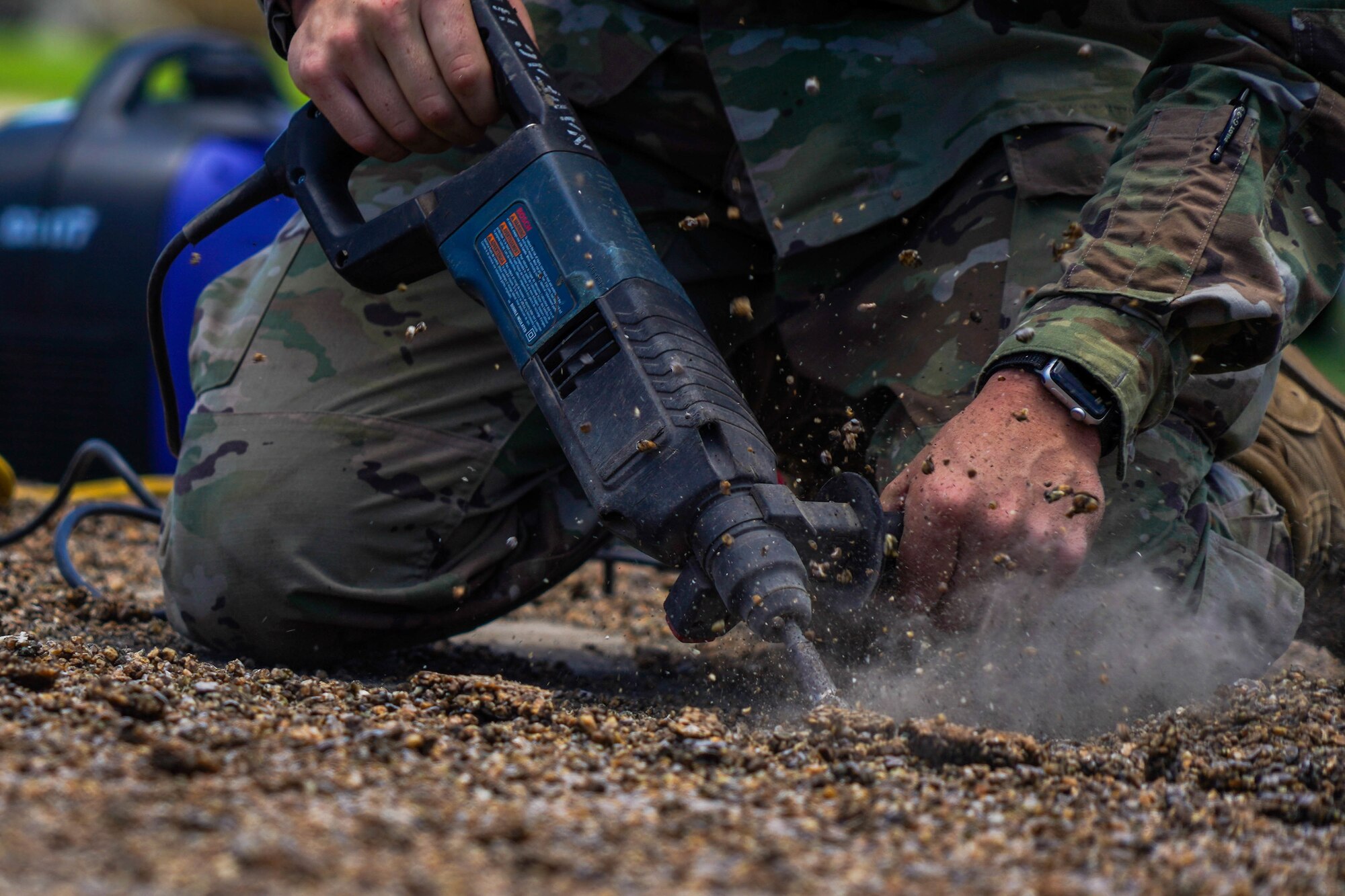 Airman 1st Class Tyler Williams, 647th Civil Engineer Squadron structures journeyman, clears the static display pad at Joint Base Pearl Harbor-Hickam, Hawaii, August 3, 2021. The static display pad is scheduled to house two new model aircraft to be displayed in front of the 15th Wing Headquarters building. (U.S. Air Force photo by Airman 1st Class Makensie Cooper)