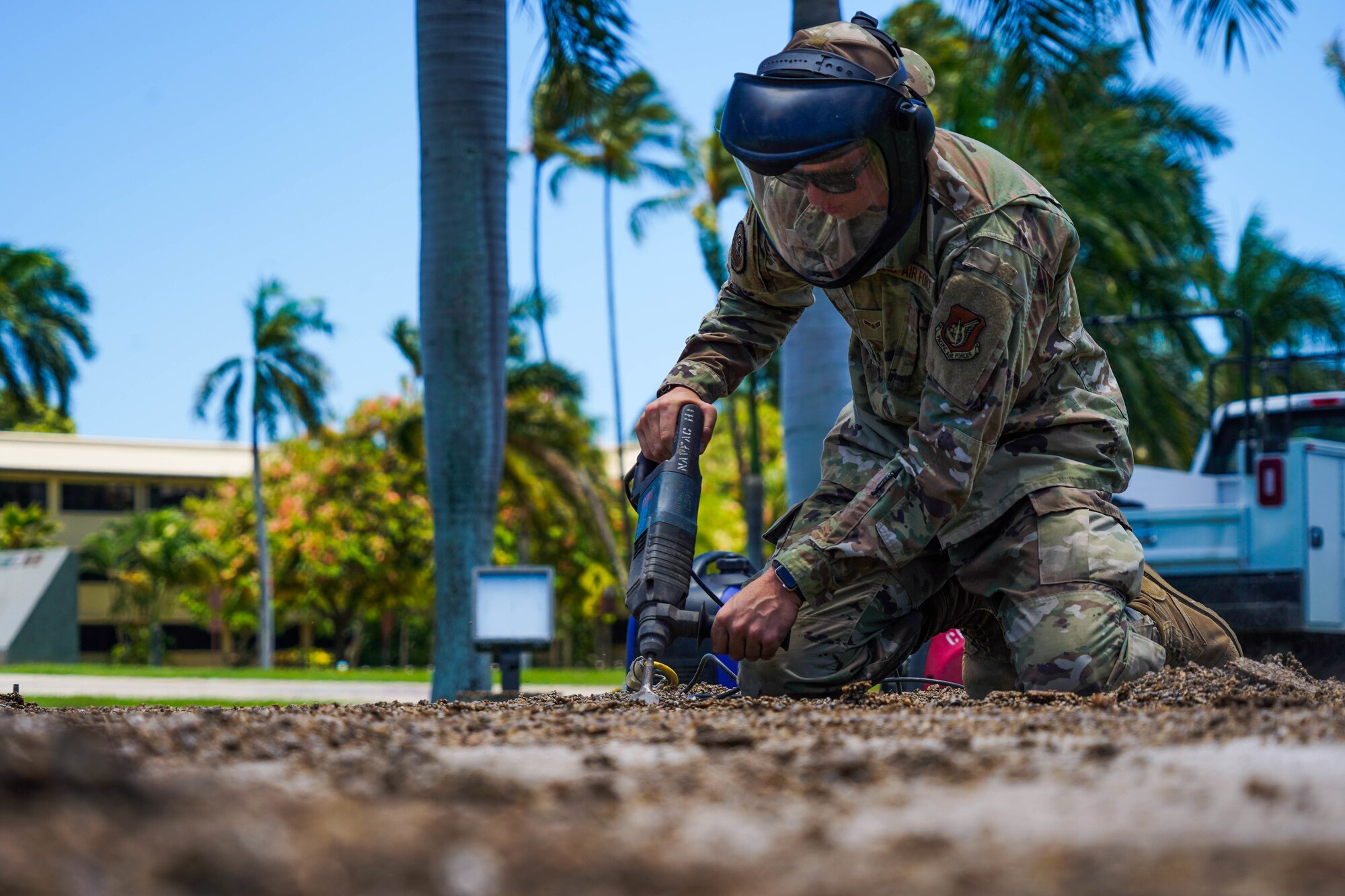 Airman 1st Class Tyler Williams, 647th Civil Engineer Squadron structures journeyman, clears the static display pad at Joint Base Pearl Harbor-Hickam, Hawaii, August 3, 2021. The static display pad is scheduled to house two new model aircraft to be displayed in front of the 15th Wing Headquarters building. (U.S. Air Force photo by Airman 1st Class Makensie Cooper)