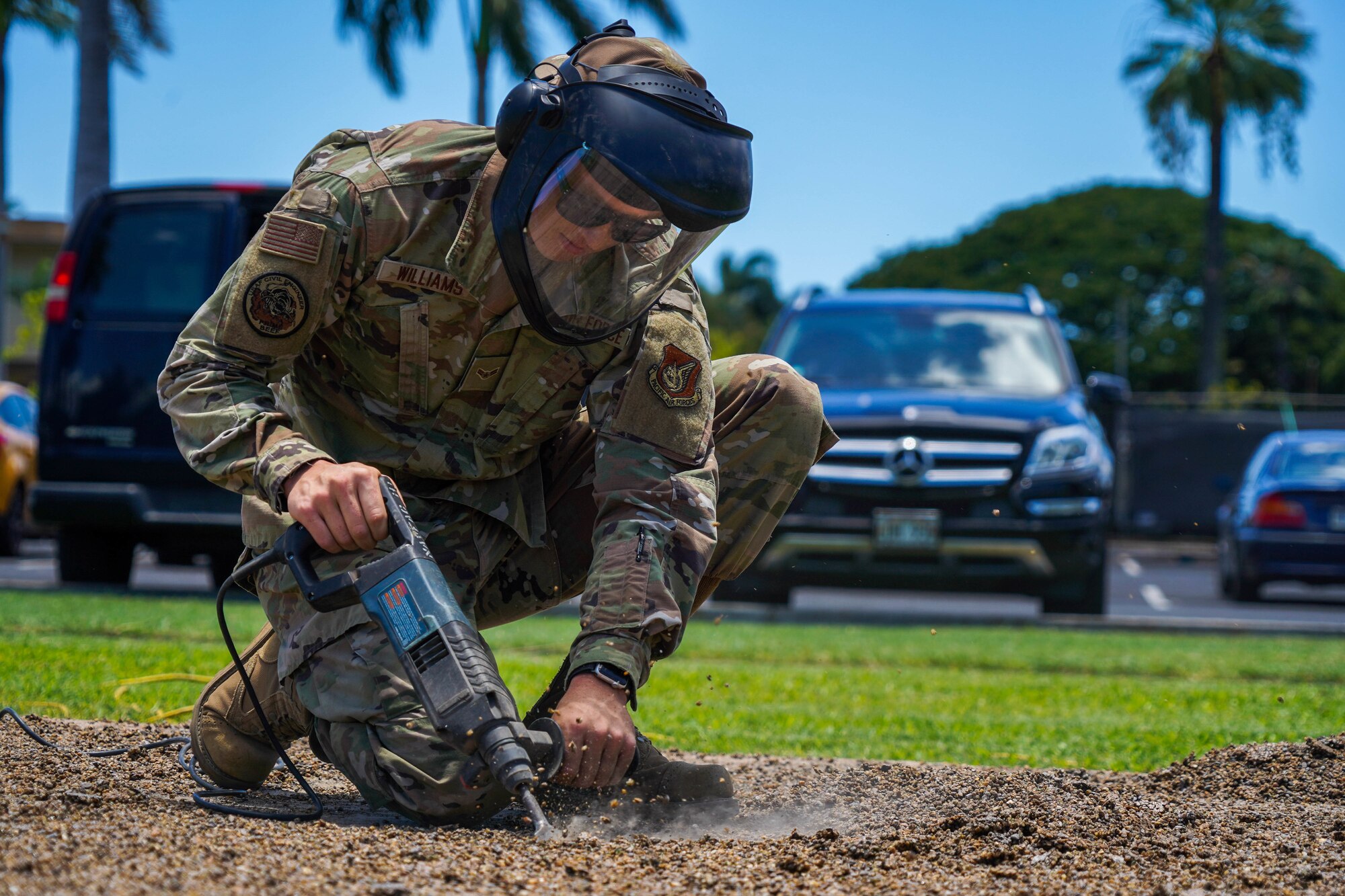 Airman 1st Class Tyler Williams, 647th Civil Engineer Squadron structures journeyman, clears the static display pad at Joint Base Pearl Harbor-Hickam, Hawaii, August 3, 2021. The static display pad is scheduled to house two new model aircraft to be displayed in front of the 15th Wing Headquarters building. (U.S. Air Force photo by Airman 1st Class Makensie Cooper)