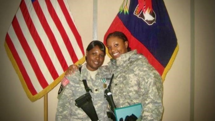 female soldier hugs female soldier and mother