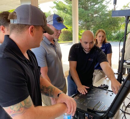 An industry partner explains a camera display for a robotic dog during a demonstration in Indian Head, Maryland, Aug. 2, 2021. The demonstration was part of the Eastern National Robot Rodeo and Capabilities exercise, an event the Air Force Civil Engineer Center utilizes to partner and explore future industry technologies for the explosive ordnance disposal community.