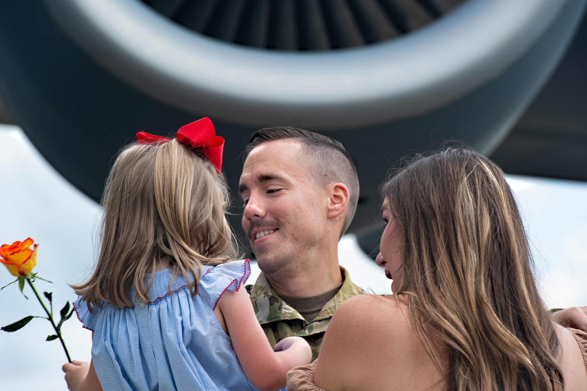 Capt. Dan Tenpas, 16th Airlift Squadron pilot, hugs his wife and daughter after returning from his deployment at Joint Base Charleston, S.C., Aug. 8, 2021.